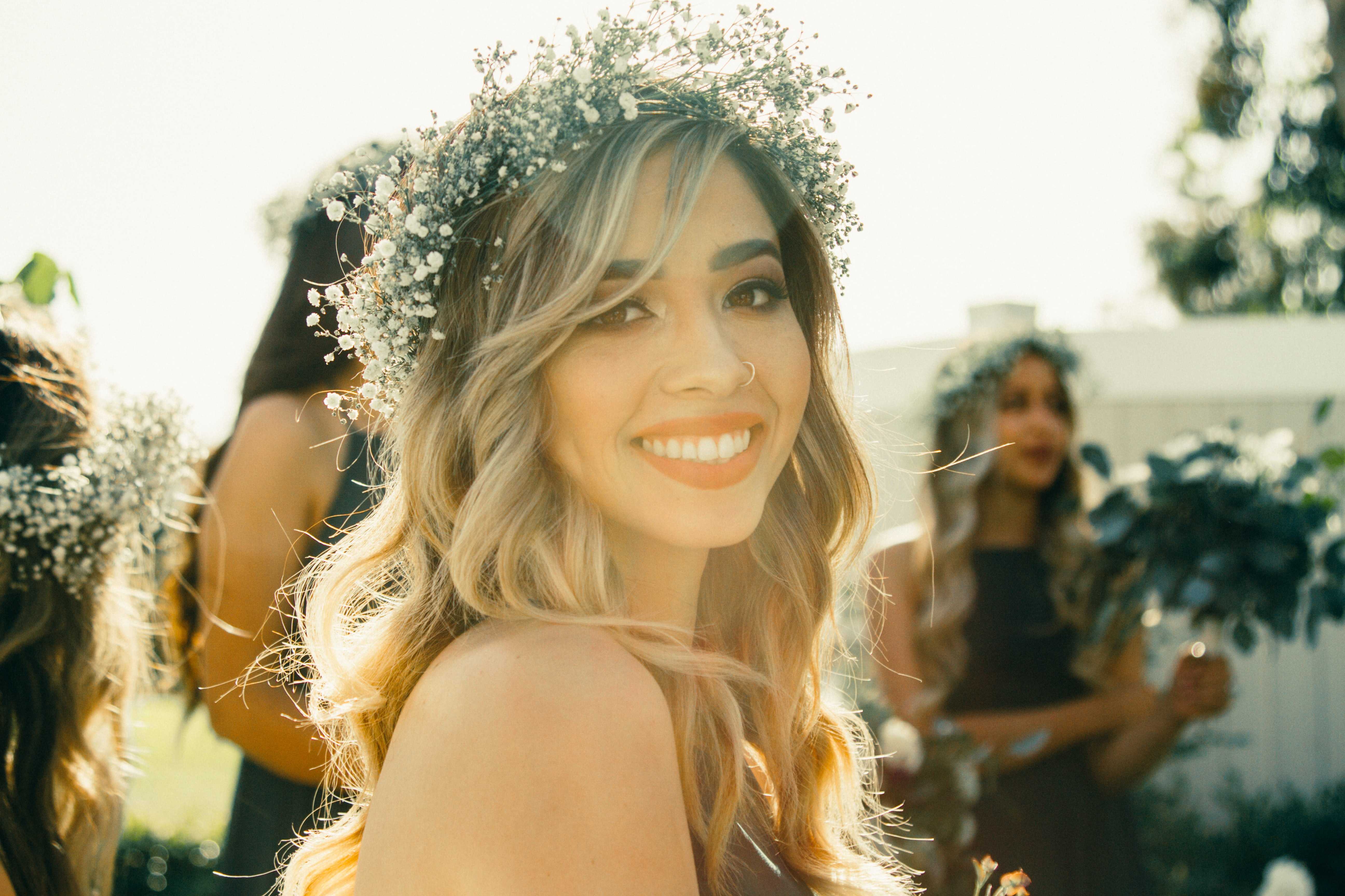 A pretty woman with a floral crown wearing stylish clothes